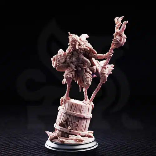 Baba Yaga Ancient Witch resin miniature by DM Stash, shown from the front with twisted staff, barrel base, layered clothing, bones, baskets, and dark fairy tale witch details.