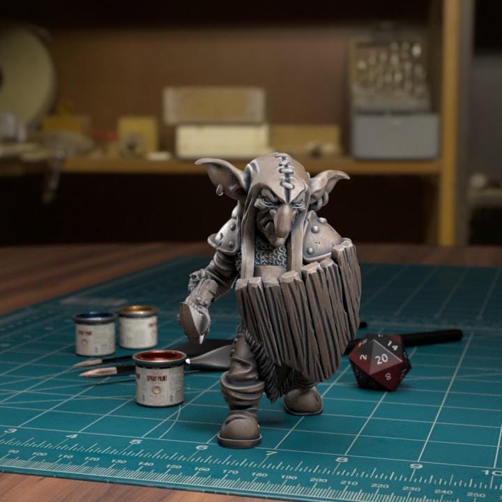 Resin 3D‑printed goblin raider miniature by TytanTroll holding an oversized curved blade and wooden shield. 