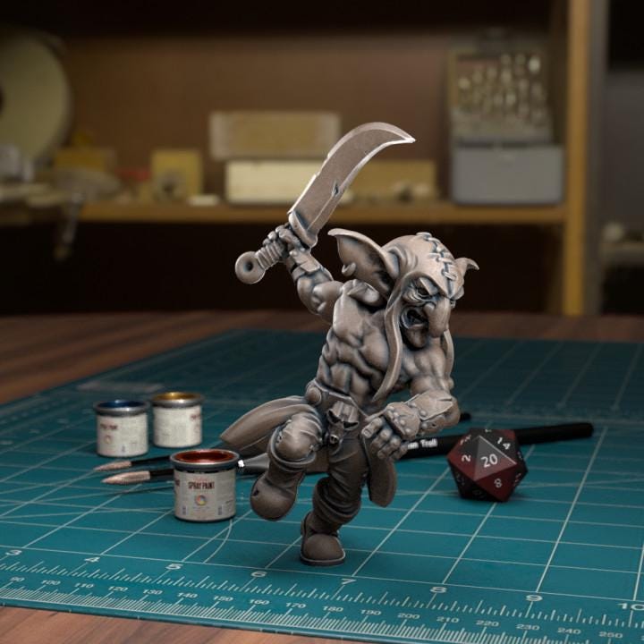 Resin 3D‑printed goblin raider miniature by TytanTroll holding a single large blade overhead.