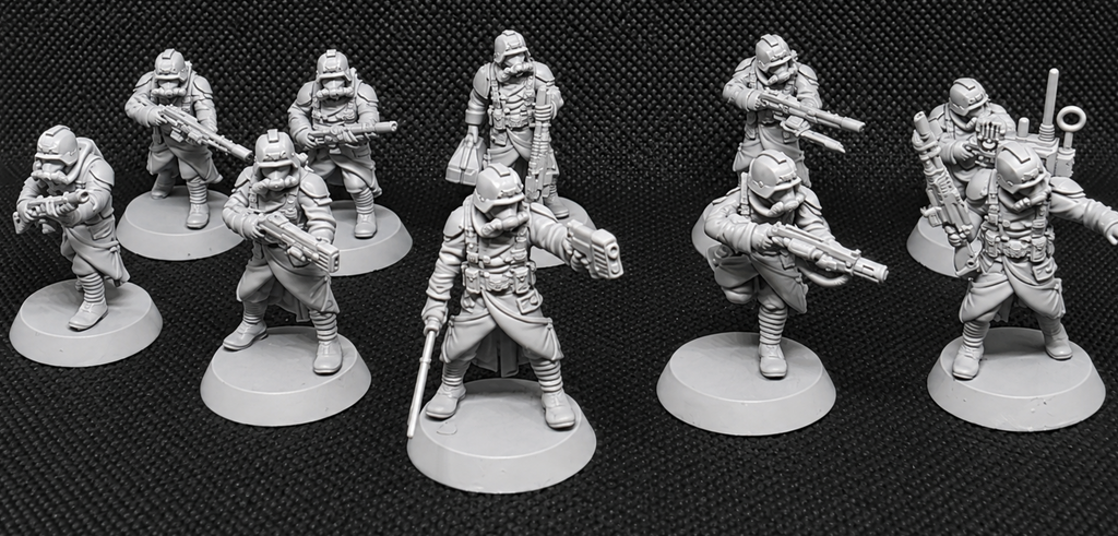 Ten pre-assembled GrimGuard Infantry resin miniatures by StationForge posed as a complete sci-fi trench warfare squad.