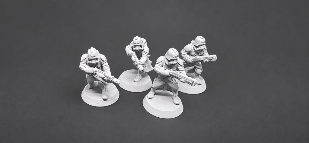 Four GrimGuard Infantry special-weapon miniatures by StationForge with heavy sci-fi weapons, helmets, and gas masks.