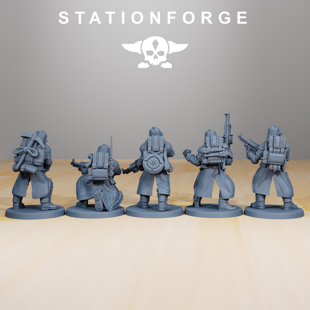 Rear view of five GrimGuard Tinkers miniatures showing backpacks, coats, utility gear, armor plates, and sculpted resin details.