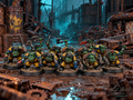Hand-painted Guttertech Orc Raiders by Trollet Miniatures in yellow armor, posed in a rusty industrial scrapyard.