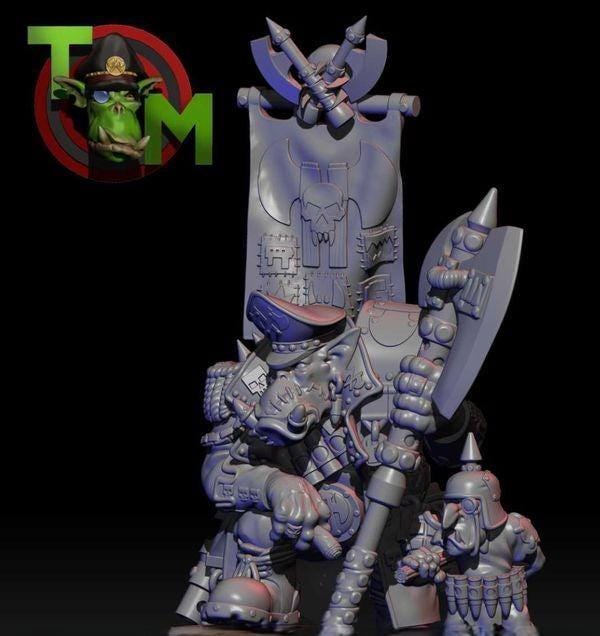 Resin fantasy goblin boss miniature by Trollet Miniatures, featuring a heavily armored leader with a massive axe, oversized banner, skull details, and a smaller goblin companion.