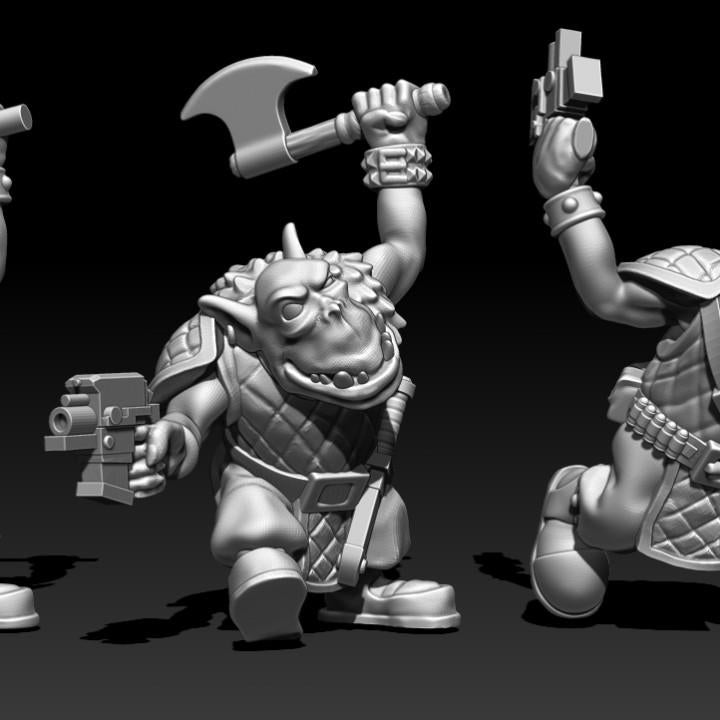 Guttertech Goblin Raider miniatures with raised weapons and sci-fi blasters, showing quilted armor, goggles, helmets, and energetic tabletop poses.