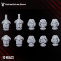 Legio Artemis Bellatrix Squad head options by DakkaDakka, showing 10 resin miniature heads with helmeted and unhelmeted female sci-fi warrior styles.