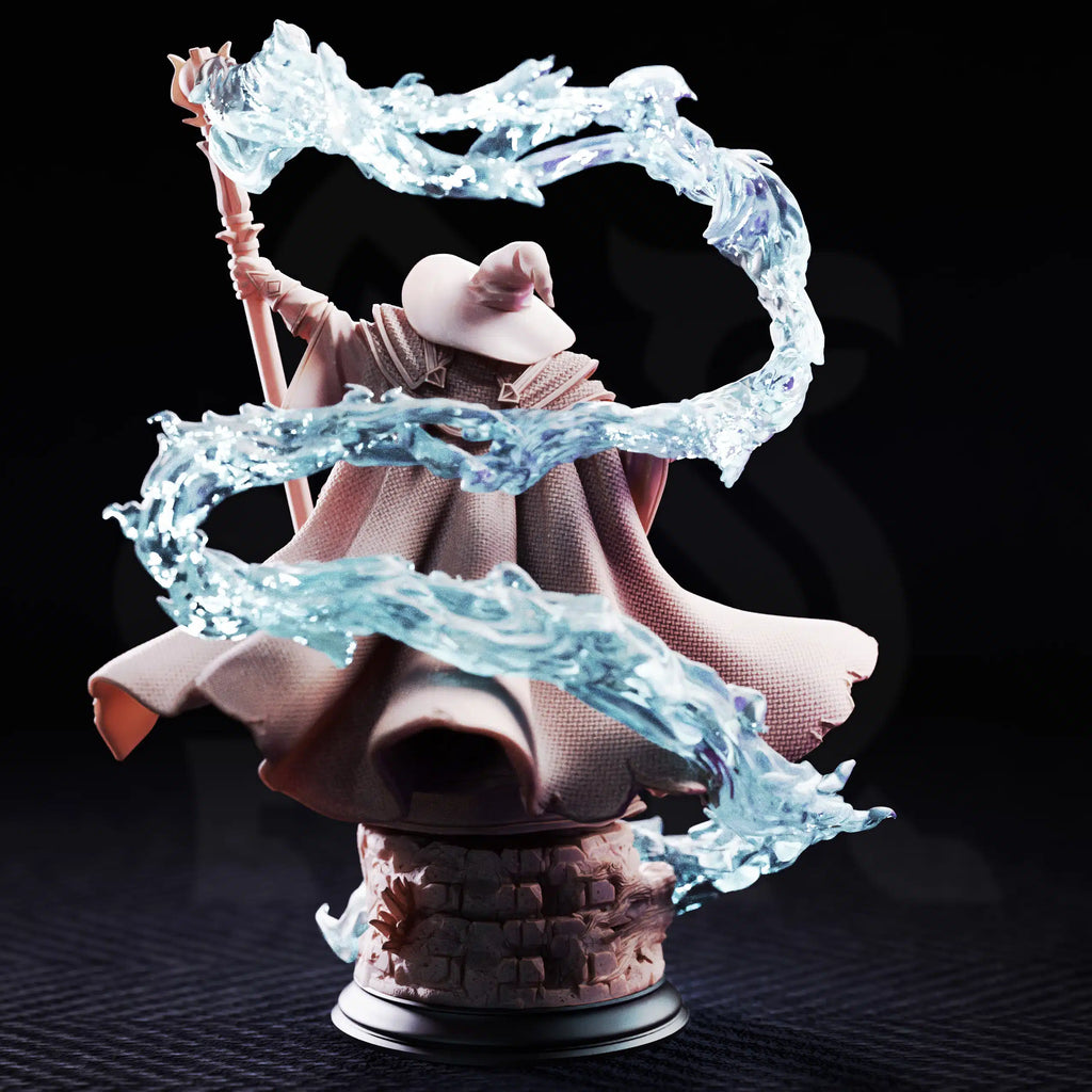 Rear view of Merlin of Monmouth by DM Stash, showing the elder wizard’s flowing cloak, tall hat, staff, stone base, and swirling magical effect.