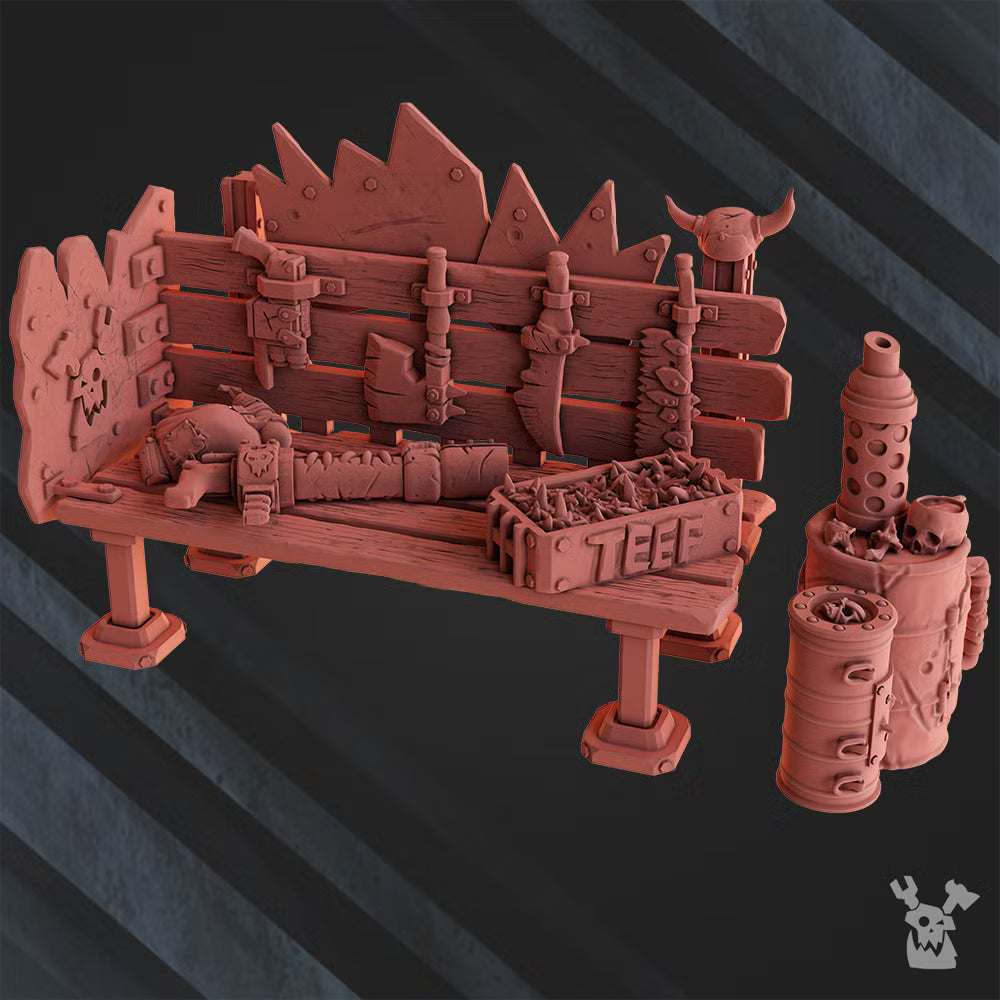 Close view of the sci-fi orc weapon workbench terrain piece, with spiked wooden barricade, tools, weapons, ammo crate, and industrial barrel detail.