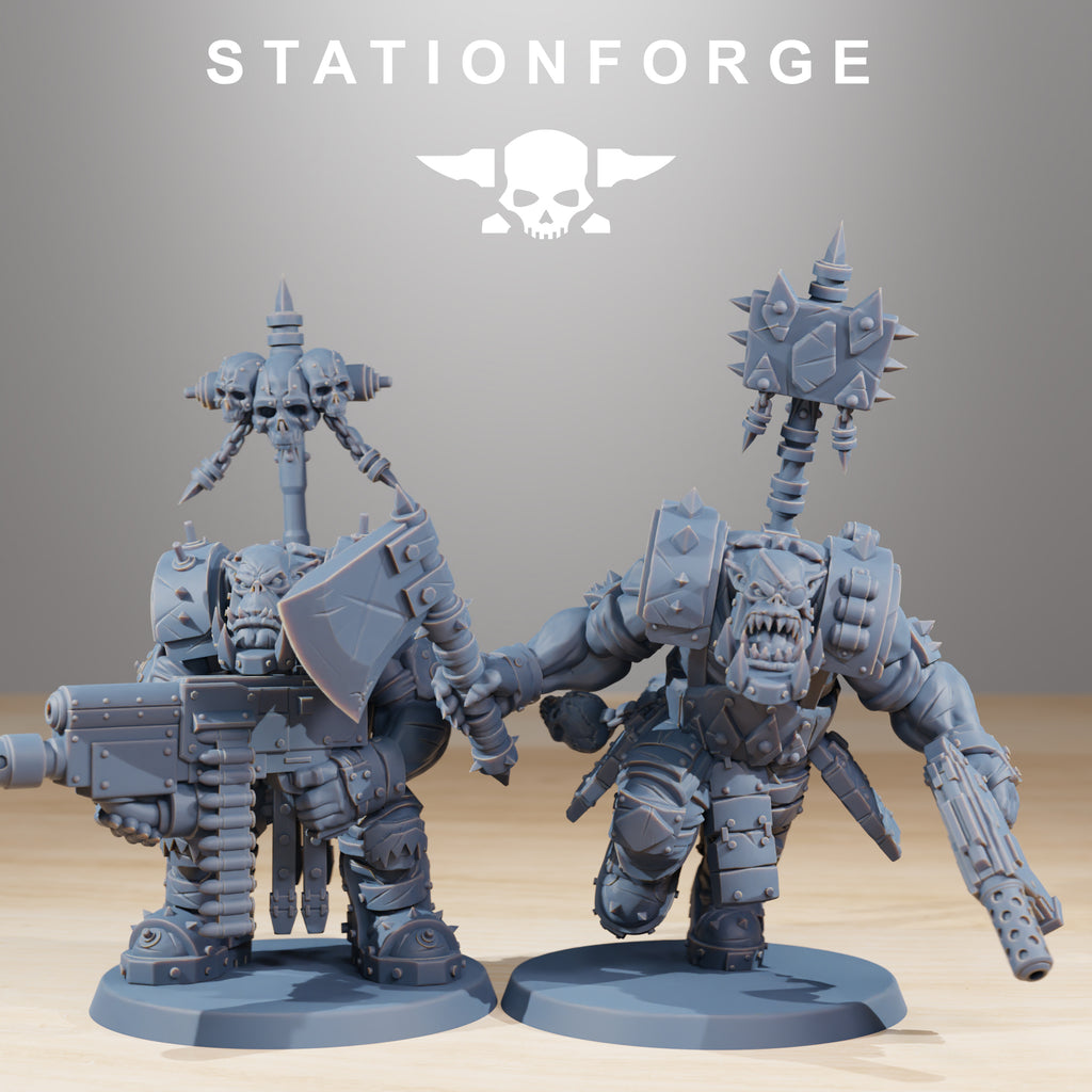 Two Orkaz SkullKrushers by Station Forge, showing a belt-fed heavy gunner and a charging Orkaz warrior with axe, pistol, and banner pole.