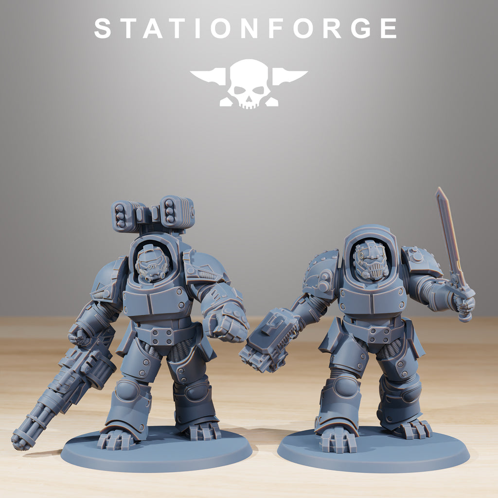 Two Socratis Vanguard sci-fi miniatures with heavy weapons, sword, and bulky armor.