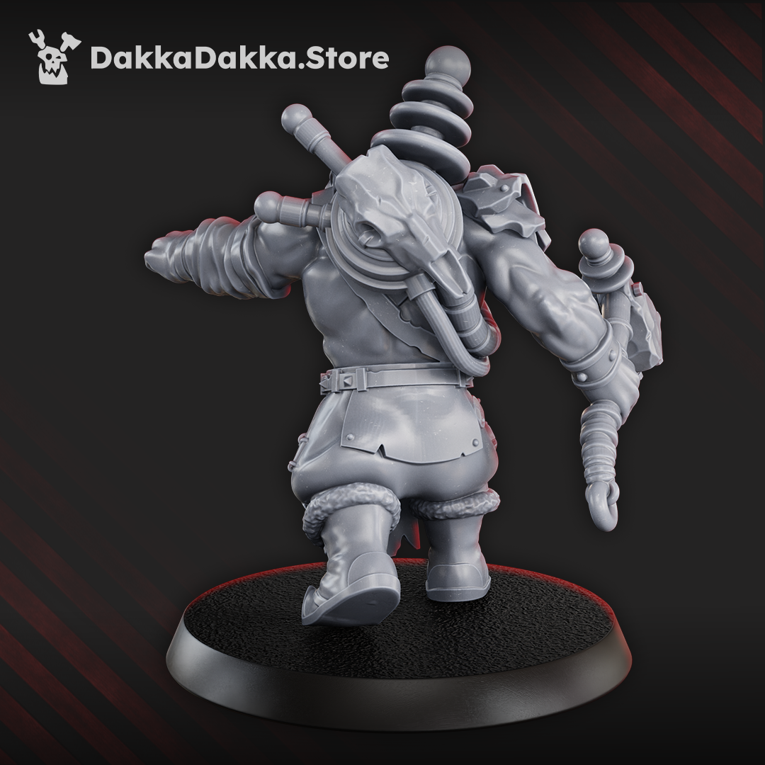 Rear view of the Tech Boy showing his back-mounted power unit, electrical coils, cables, armored shoulder plate, hammer, and fur-trimmed clothing.
