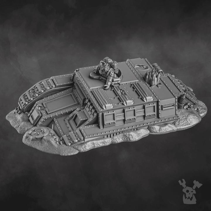 Resin 3D‑printed Wrecked Tank Terrain by DakkaDakka showing a heavily damaged armored vehicle embedded in textured ground with exposed tracks, torn plating, vents, pipes, and scattered debris.