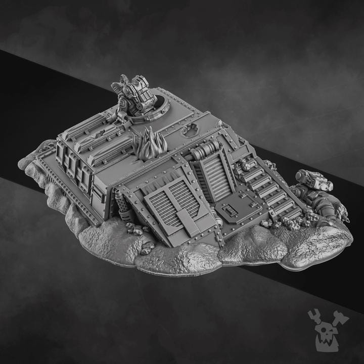 Resin 3D‑printed Wrecked Tank Terrain by DakkaDakka depicting a partially buried armored structure with vented doors, a rooftop turret, damaged panels, piping, rubble, and rocky base details.