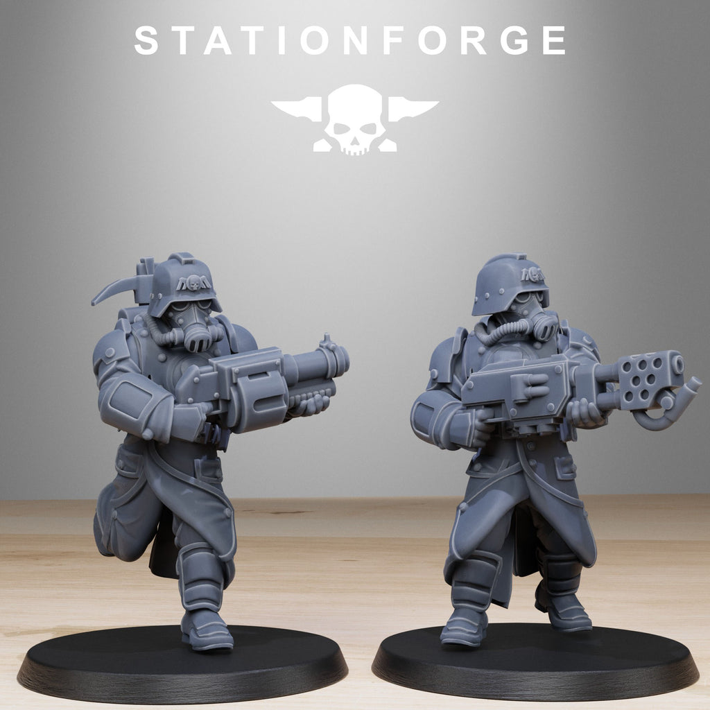Two Grimguard Bombardiers resin miniatures advancing with heavy sci-fi weapons, gas-mask helmets, and armored coats.
