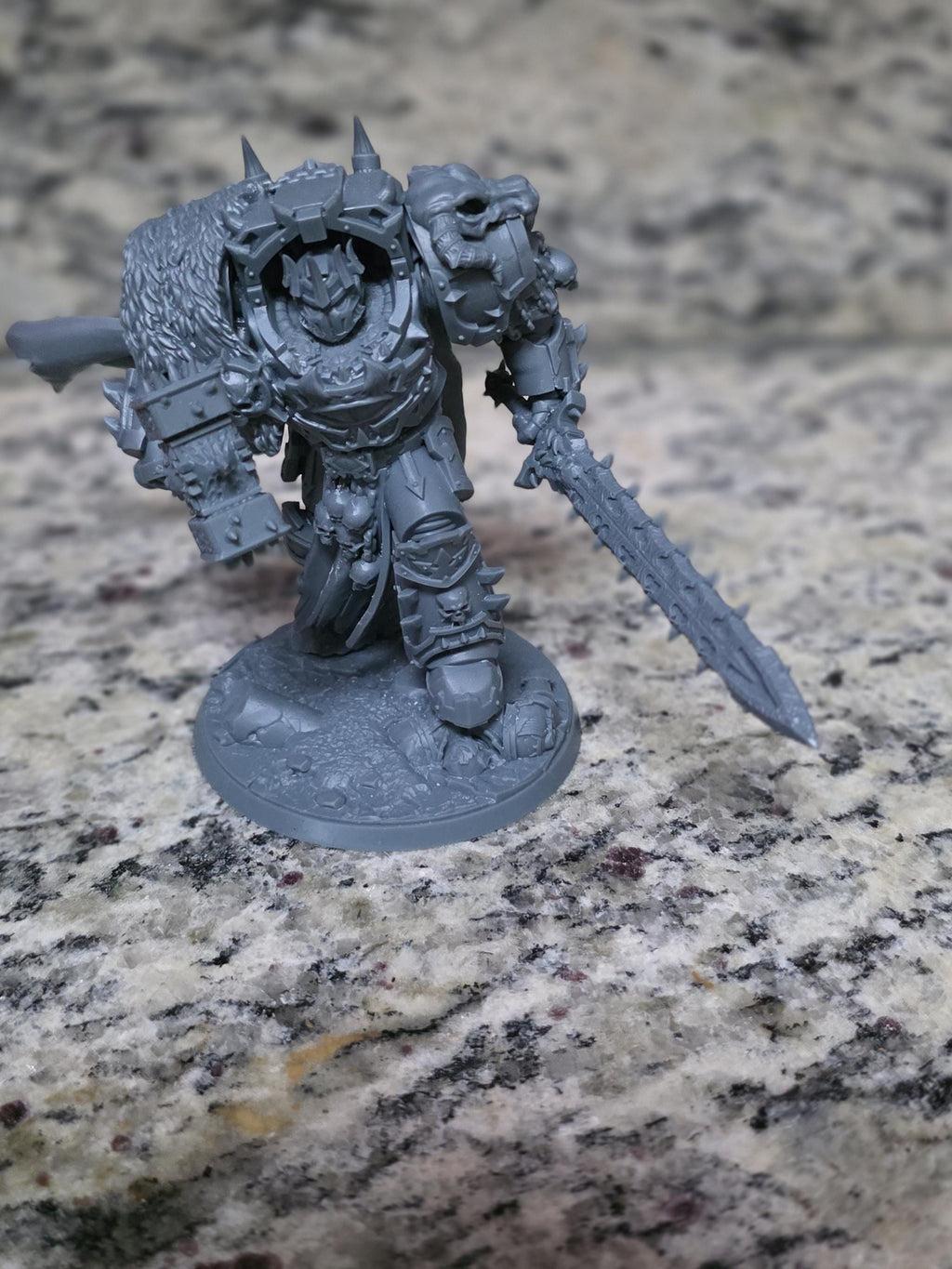 Ammon the Traitor miniature by Ghamak, a dark sci-fi commander with heavy armor holding a sword and plasma pistol
