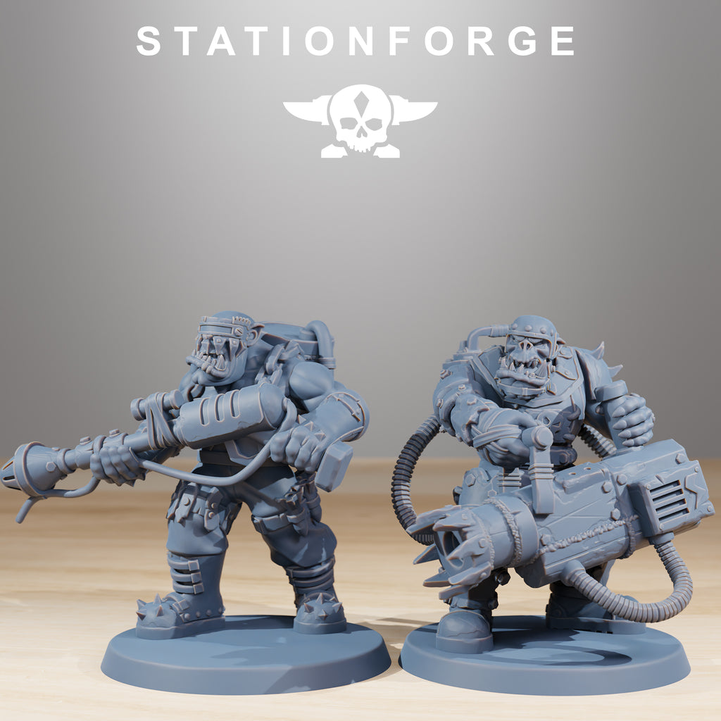 Two Orkaz Skillers miniatures by Station Forge carrying heavy sci-fi weapons with hoses, armor plates, and rugged battlefield styling.