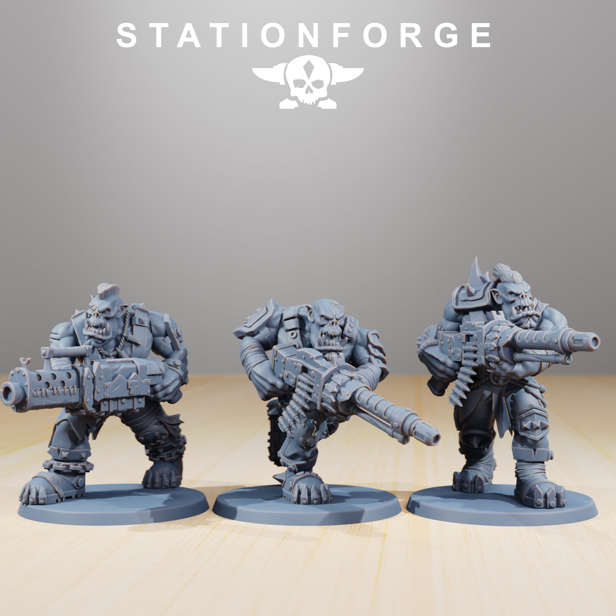 Three Orkaz Strappaz heavy weapon miniatures by Station Forge, shown with oversized sci-fi firearms and bulky armored poses.