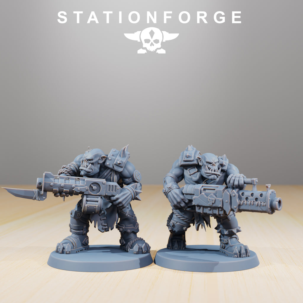 Two Orkaz Strappaz miniatures by Station Forge carrying oversized sci-fi firearms, ideal for heavy infantry tabletop units.